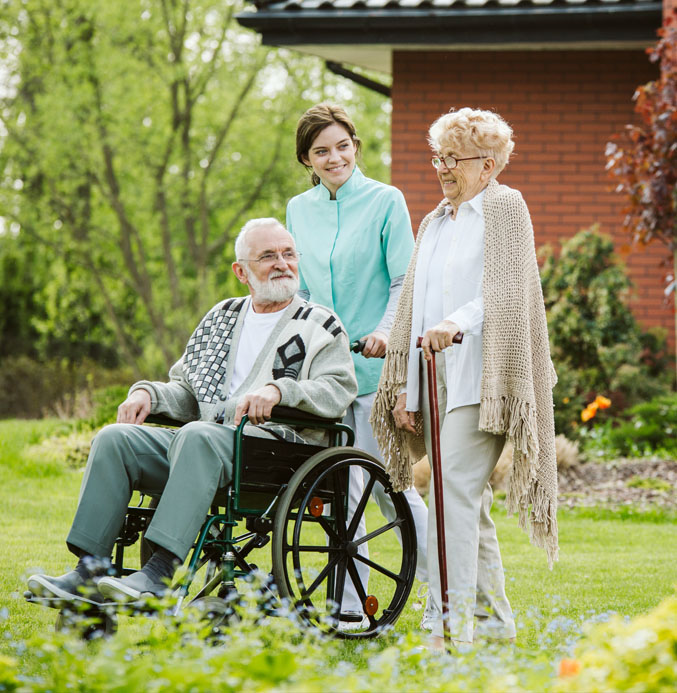 carehome_staff_carer in garden with elderly couple carehome_staff_carer in garden with elderly couple